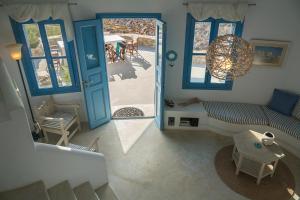 a living room with a blue door and a couch at Villa Mikros Vorias in Karavostasi