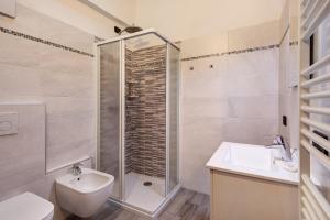 a bathroom with a shower and a sink and a toilet at Casa Nicoletta inverno in Livigno