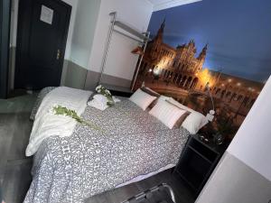 a bedroom with a large bed with a view of a building at Hostal Paco´s in Seville