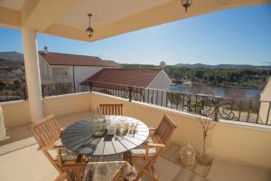 a table and chairs on a balcony with a view at The Residence in Šibenik