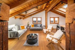 a living room with a couch and a table at Haus Genepy in Zermatt