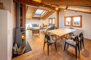 a living room with a table and a fireplace at Haus Genepy in Zermatt