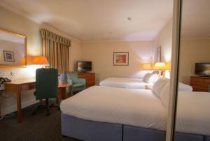 Cama ou camas em um quarto em Tong Park Hotel