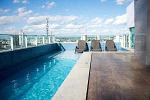 a swimming pool on the roof of a building at Unico Apart Hotel in Feira de Santana