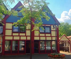 a building with a tree in front of it at Hotel an der Uffe in Bad Sachsa +21 photos