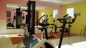 a gym with several exercise bikes and a mirror at ibis Orange Sud in Orange