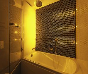a bathroom with a shower and a bath tub with a shower at Bristol Art & Medical SPA in Busko-Zdrój