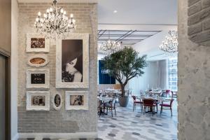 a dining room with tables and pictures on the wall at Paramount Hotel Midtown in Dubai