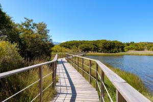 a wooden bridge over a body of water at U Paesolu in Sainte-Lucie de Porto-Vecchio