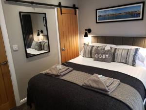 a hotel room with a bed with towels on it at The Courtyard - Cosy, secluded with luxury suite in Walmer