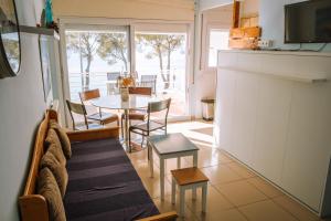 a kitchen and dining room with a table and chairs at Agi Marina Apartments in Roses