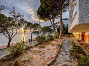 a walkway next to a building next to the water at Agi Marina Apartments in Roses