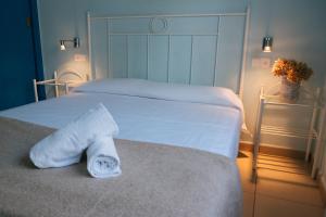 a bedroom with two beds with white sheets and towels at Agi Marina Apartments in Roses