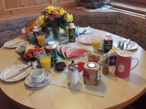 - une table avec des aliments et des boissons pour le petit-déjeuner dans l'établissement Triembachhof, à Schönau am Königssee