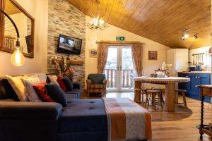 a living room with a couch and a table at Greenvale Cabins in Forkill