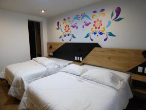 Postel nebo postele na pokoji v ubytování Platero Hotel