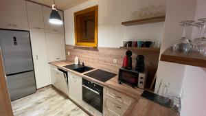 a kitchen with a sink and a stove at Chata na samote - Kráľova Lehota in Kráľová Lehota