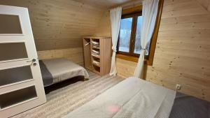 a small room with a bed and a window at Chata na samote - Kráľova Lehota in Kráľová Lehota