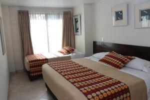 Postel nebo postele na pokoji v ubytování Hoteles Bogotá Inn Lago Chico Zona Rosa + 20 fotografií