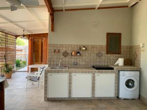 a kitchen with a sink and a washing machine at Casa Vacanza Villa Giovanna in Valderice