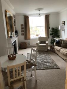 a living room with a table and chairs at Beautiful riverfront cosy one bedroom apartment in Upton upon Severn