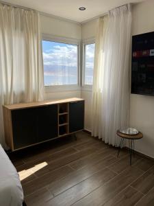 a bedroom with a bed and a large window at מגדל חי in Eilat