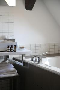 a bathroom with a sink and towels on a counter at Hôtel Quatorze in Colmar