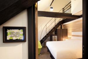 A bed or beds in a room at Hotel Le Colombier Suites