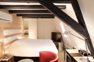 Postel nebo postele na pokoji v ubytování Hotel Le Colombier Suites