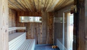 a sauna with wooden walls and a wooden ceiling at Appartement Hauser in Zell am Ziller