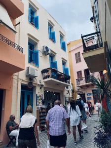 a group of people walking down a street at DIONI in Chania Town