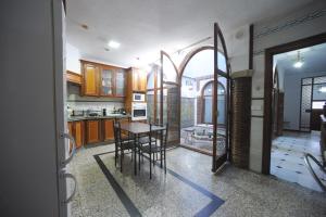 a kitchen with a table and chairs in it at San Basilio´s Red House in Córdoba