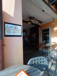 a restaurant with a sign on the side of a wall at La Tana del Ghiro Locazione Turistica in Sedico