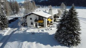 an aerial view of a house in the snow at Chesa Suot Ovas in Sils Maria