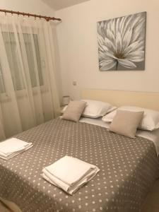 a bedroom with a bed with two towels on it at JELSA center-Sea view apartment near the beach - B2 in Jelsa