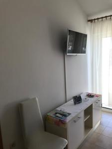 a room with a desk with a chair and a tv on the wall at JELSA center-Sea view apartment near the beach - B2 in Jelsa
