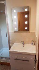 a bathroom with a sink and a mirror and a shower at Modern 1 bed Apartment close to Campbeltown in Campbeltown +12 photos