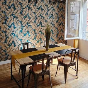 a dining room table with chairs and a potted plant at La Gaillardise - love room - Spa & Sauna - Espace privatif in Brive-la-Gaillarde +24 photos