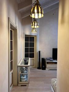 a room with a room with a wine rack and a chandelier at Garmisch Lux Apartment mit Sauna in Garmisch-Partenkirchen +23 photos