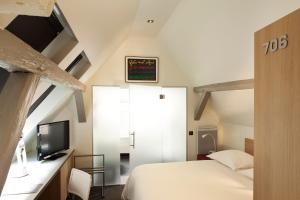 Postel nebo postele na pokoji v ubytování Hotel Le Pavillon 7