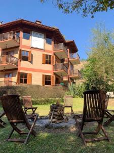 a group of chairs sitting in front of a building at Riacho Das Pedras Pousada in Gonçalves