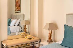 a living room with a bed and a mirror at Zen Hotel in Athens