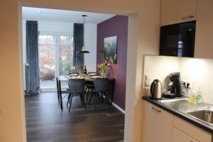 a kitchen and dining room with a table and chairs at Ferienwohnung Zacharias in Bad Hersfeld