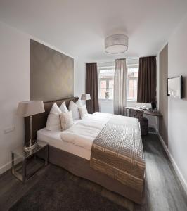 a bedroom with a large bed and a window at Haus am Hühnerdieb in Aachen