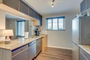 a kitchen with blue cabinets and stainless steel appliances at Nashville Flat Close to Downtown 101 in Nashville