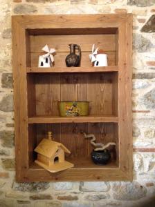 a wooden shelf on a wall with items on it at Chaihoutes stone villa into Olive farm in Zia in Ágios Dimítrios