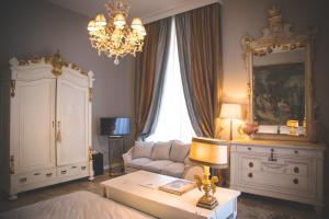 a living room with a couch and a chandelier at Arnaboldi Palace in Pavia