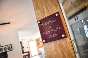 a wooden door with a sign that reads furniture and refrigerators room at Lisas - with Wellness and Breakfast in Schröcken