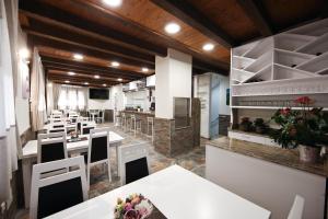 a restaurant with white tables and white chairs at VILLA DOS INFANTAS in Puebla de Sanabria +19 photos