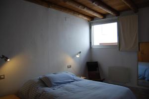 um quarto com uma cama e uma janela em CASA DE DOÑA MARIA VALDELARCO em Valdelarco